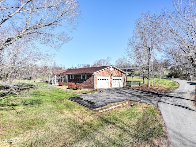 view of front of home with a front yard and a garage