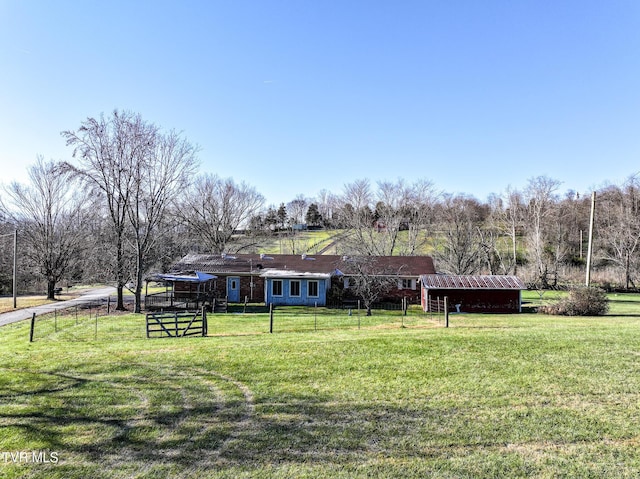 view of yard featuring a rural view and an outdoor structure