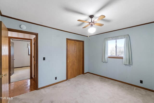 unfurnished bedroom with light parquet flooring, a closet, ceiling fan, and ornamental molding