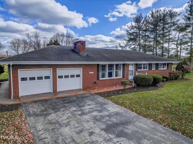 single story home featuring a garage and a front yard