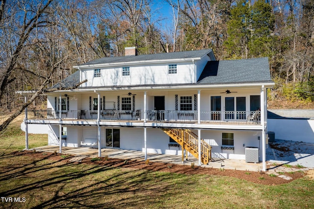 back of house featuring a yard, a patio, and central AC