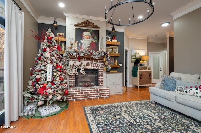 living room with hardwood / wood-style flooring, a fireplace, and crown molding