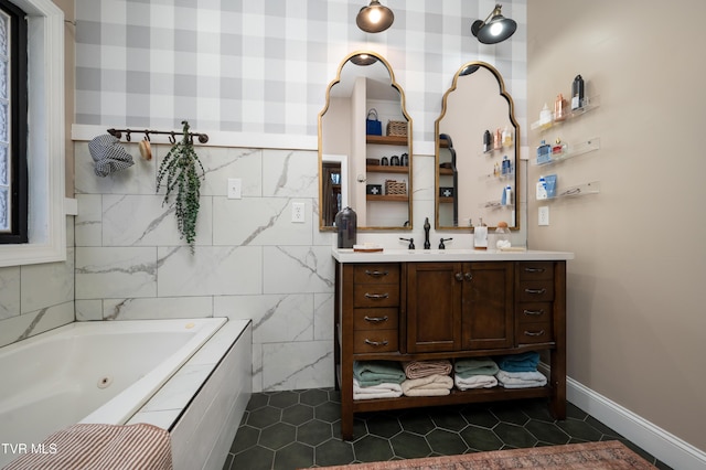 bathroom with tiled bath, tile patterned flooring, and vanity