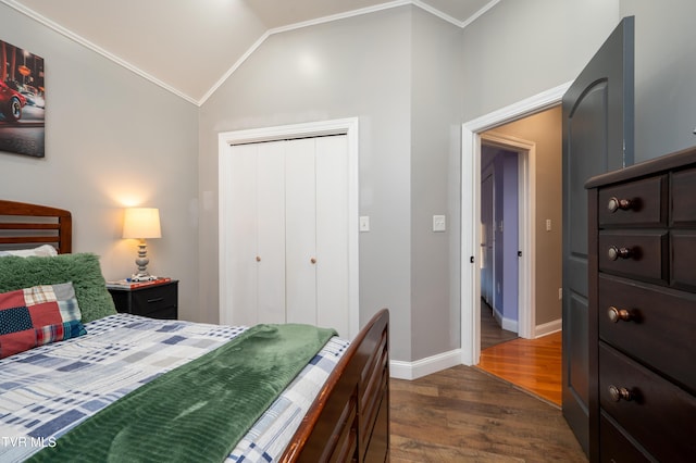 bedroom with vaulted ceiling, dark hardwood / wood-style flooring, crown molding, and a closet