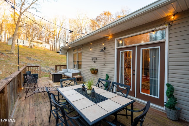 wooden deck with an outdoor living space