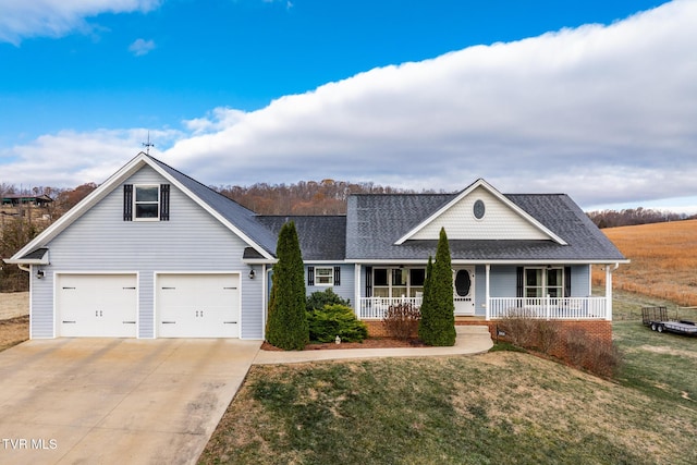 view of front of house featuring a front yard, a porch, and a garage