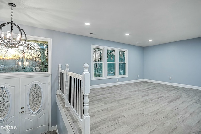 foyer featuring visible vents, wood finished floors, recessed lighting, baseboards, and a chandelier