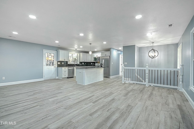 kitchen with light wood finished floors, visible vents, appliances with stainless steel finishes, and open floor plan