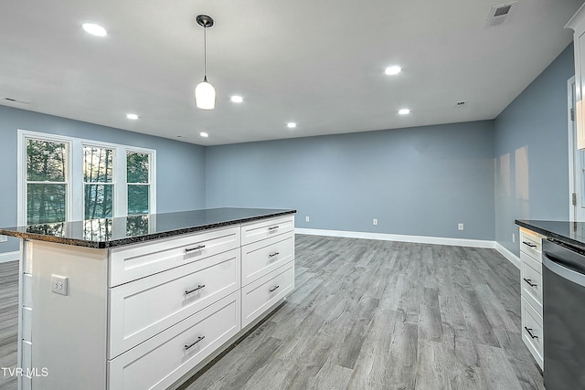 kitchen with visible vents, baseboards, light wood-style floors, and stainless steel dishwasher