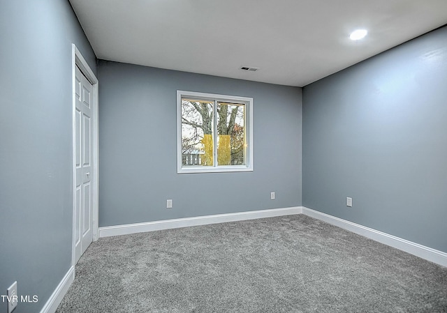 unfurnished bedroom with visible vents, baseboards, carpet, and a closet