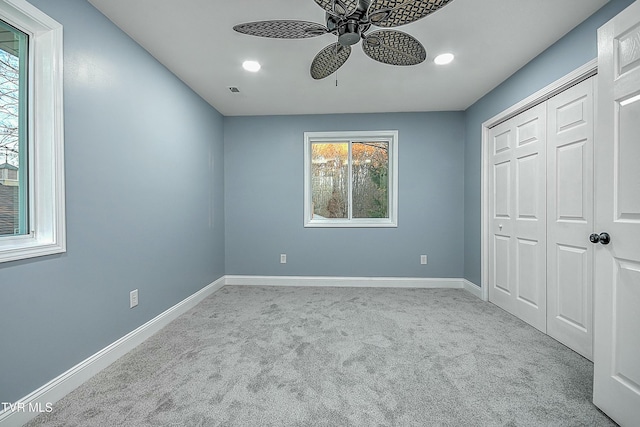 unfurnished bedroom with recessed lighting, a closet, carpet flooring, baseboards, and ceiling fan