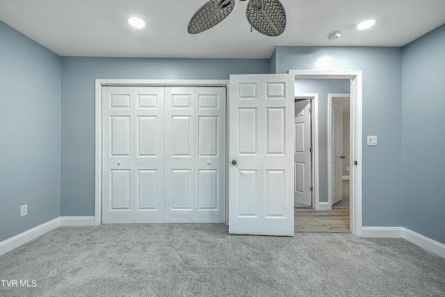 unfurnished bedroom featuring carpet flooring, a ceiling fan, baseboards, and a closet