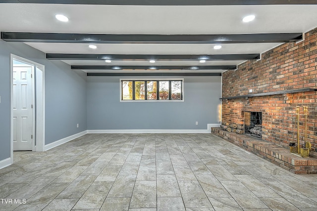 below grade area with a brick fireplace, recessed lighting, and baseboards