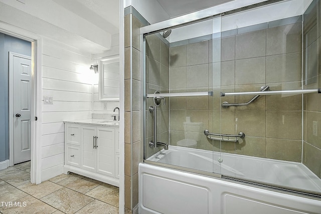 full bathroom featuring vanity and bath / shower combo with glass door