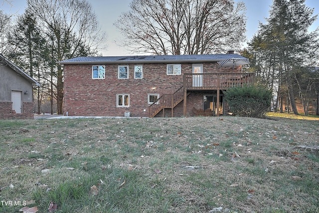 back of house featuring stairway, brick siding, and a wooden deck