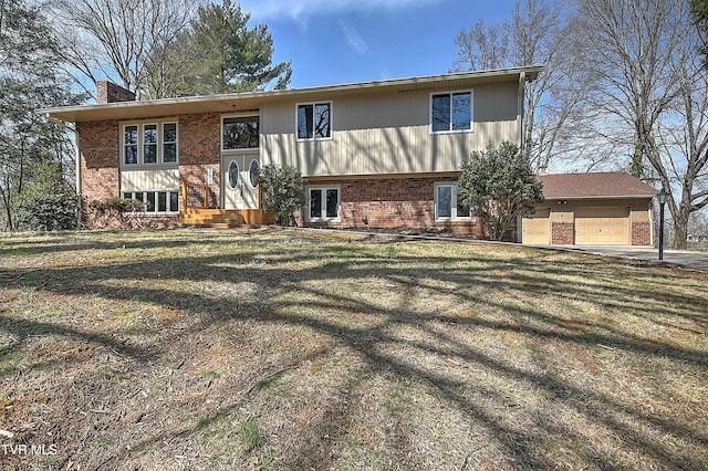 back of house with brick siding, a lawn, a chimney, and a garage