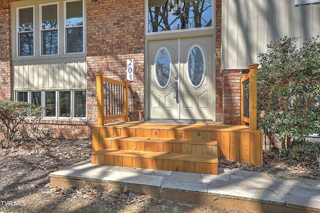 view of exterior entry with brick siding