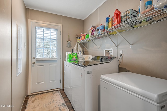 laundry area with hardwood / wood-style floors and washing machine and dryer