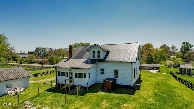 rear view of property with a yard