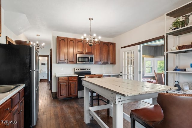 kitchen featuring stainless steel appliances, an inviting chandelier, and hanging light fixtures