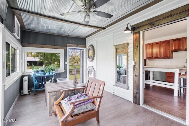 sunroom / solarium featuring a wealth of natural light and ceiling fan