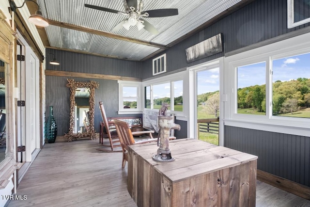 sunroom featuring ceiling fan