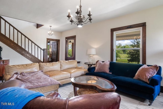 living room with light hardwood / wood-style flooring and a chandelier