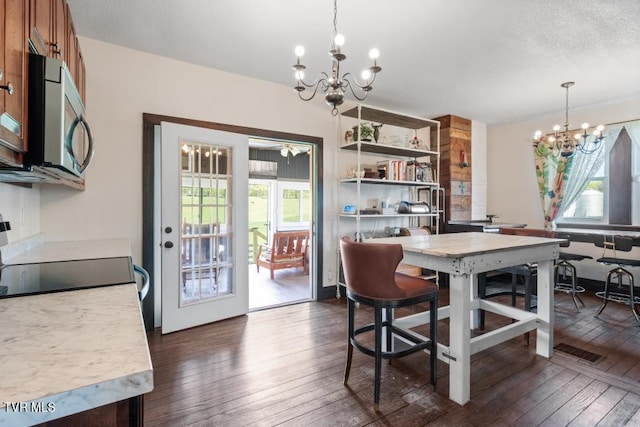 dining space featuring a chandelier and dark hardwood / wood-style floors