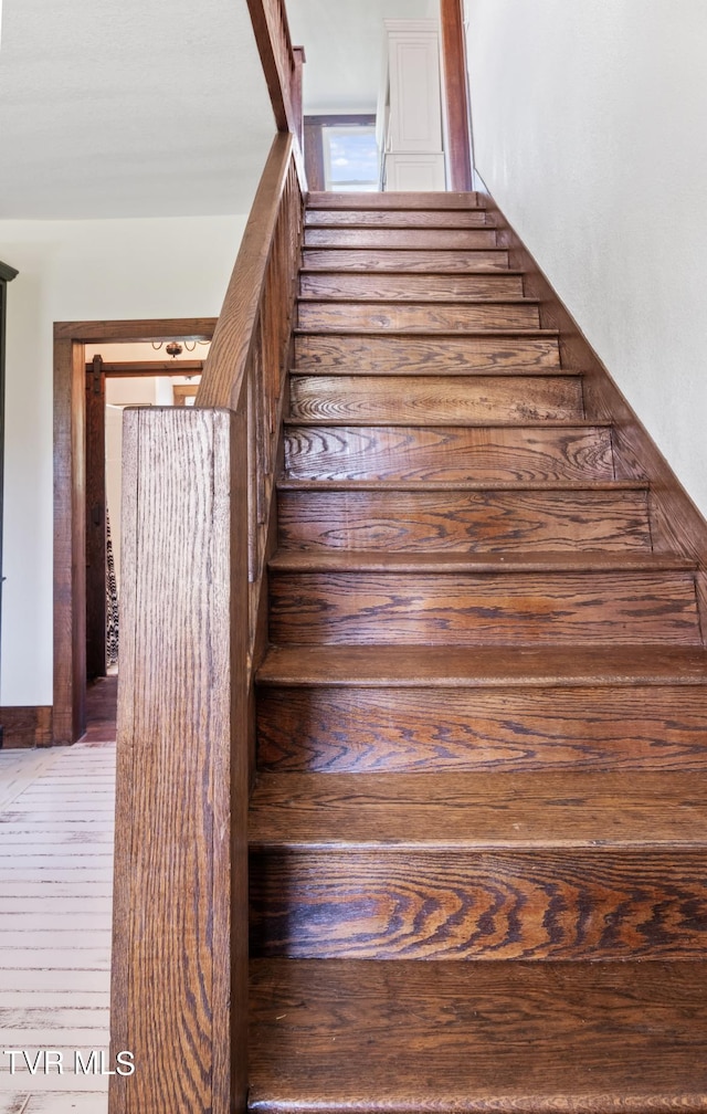 stairs featuring hardwood / wood-style flooring