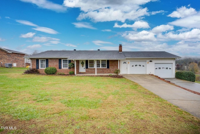 ranch-style home featuring a garage, driveway, a chimney, a front yard, and brick siding