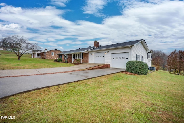 single story home featuring concrete driveway, a chimney, an attached garage, a front lawn, and brick siding