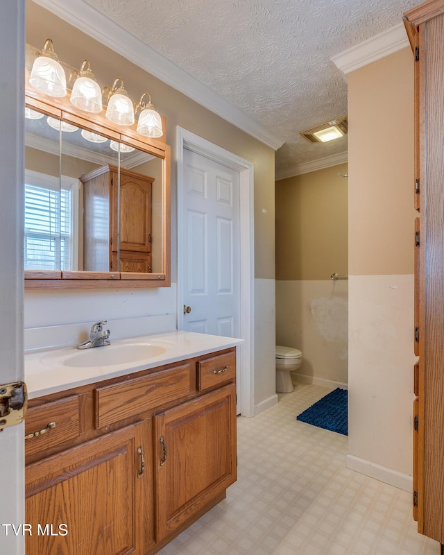 bathroom featuring crown molding, a textured ceiling, toilet, and tile patterned floors