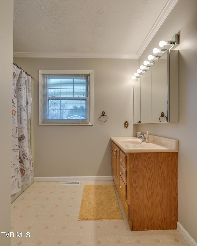 full bathroom with visible vents, ornamental molding, vanity, and baseboards