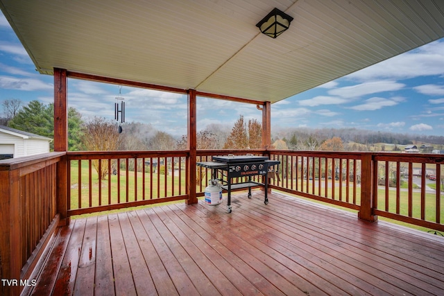 wooden terrace with a yard