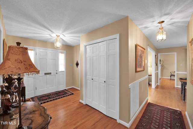 entryway featuring light hardwood / wood-style floors and a textured ceiling