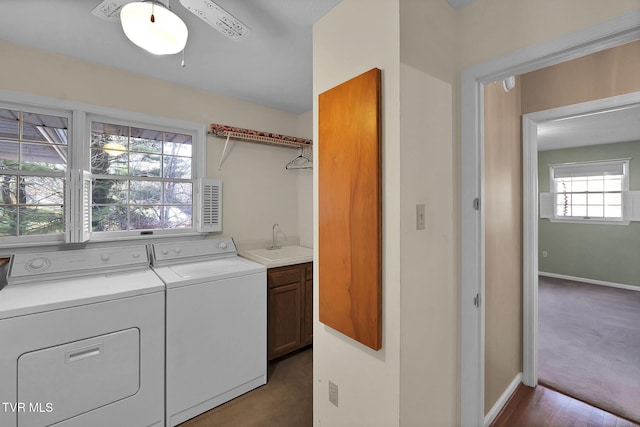 laundry room featuring separate washer and dryer, plenty of natural light, cabinets, and sink