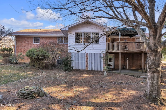 rear view of house featuring a patio area and a deck