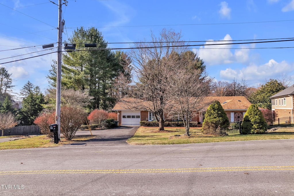 view of front of home with a front yard and a garage