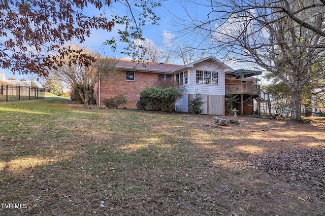 rear view of house with a yard and a deck