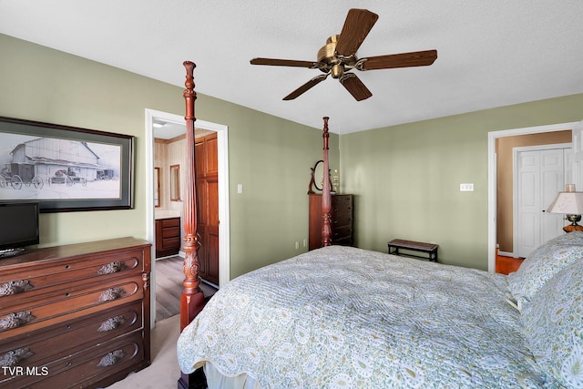 bedroom with hardwood / wood-style flooring, ceiling fan, a textured ceiling, and ensuite bath