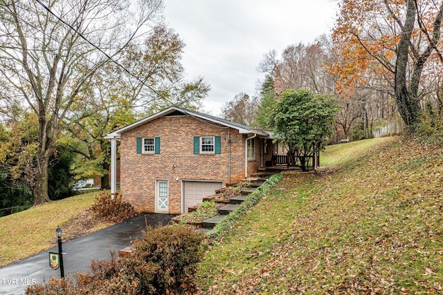 view of side of property with a lawn and a garage