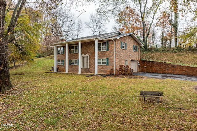 view of front of home with a garage and a front yard