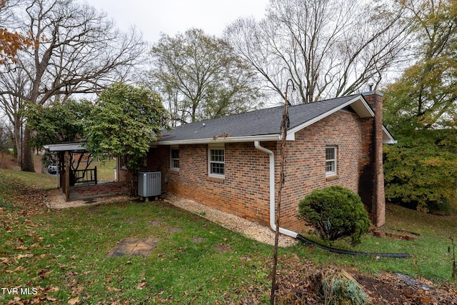 view of home's exterior with a yard and cooling unit