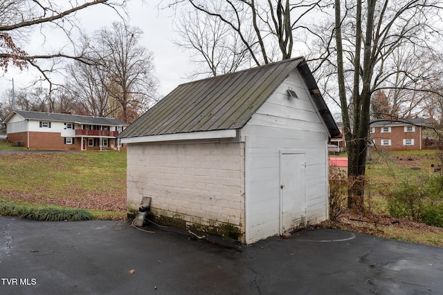 view of outdoor structure featuring a lawn