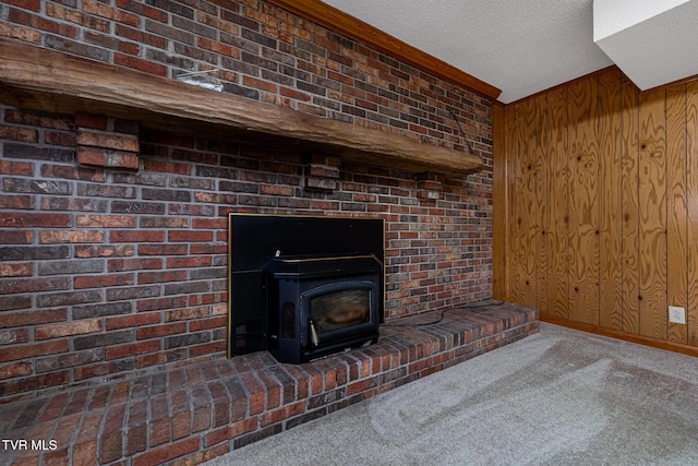 interior details with carpet flooring, a textured ceiling, a wood stove, and wood walls