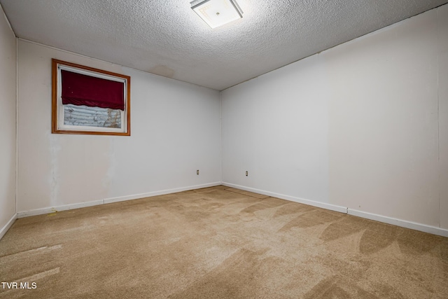 empty room featuring carpet floors and a textured ceiling