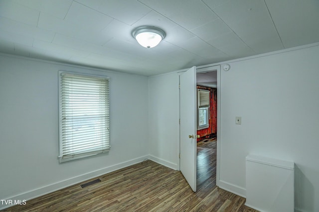 unfurnished room featuring dark hardwood / wood-style flooring