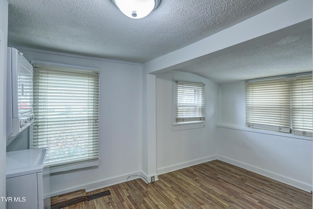 unfurnished room with a textured ceiling and hardwood / wood-style flooring