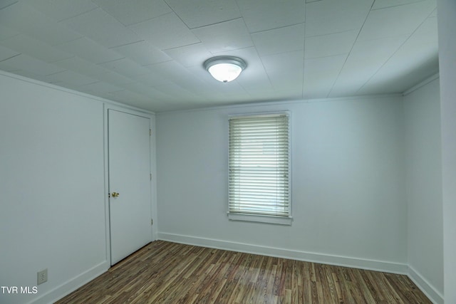 spare room with dark hardwood / wood-style flooring