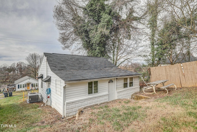 exterior space with a lawn and cooling unit